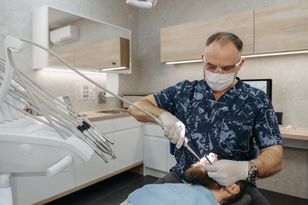 A dentist operating on a patient in his office