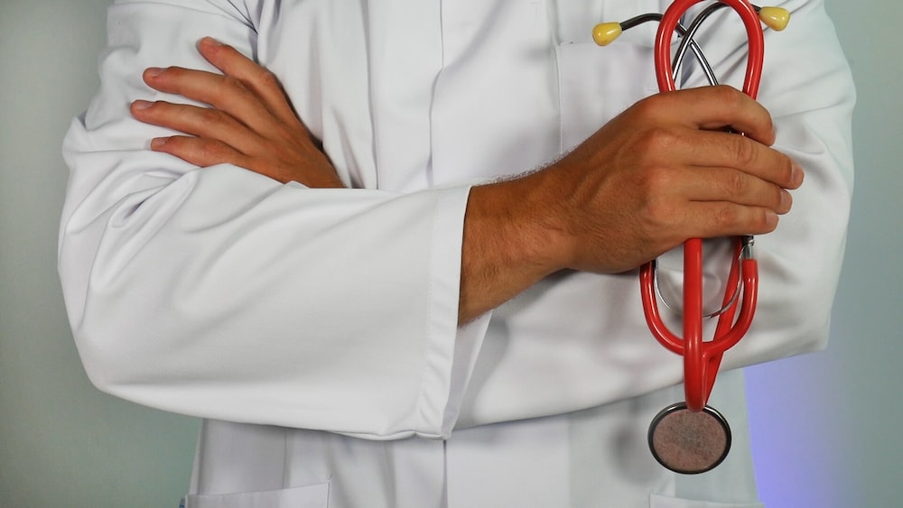 a doctor wearing a lab coat holding a stethoscope