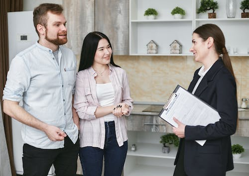 A young couple talking to an insurance agent